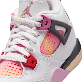 Kids sneaker close-up of laces and tongue, white with pink lace holder and red accents