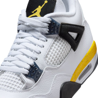 Close-up of men's white sneaker upper with black lace wings, navy details, yellow stripe