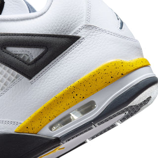 Close-up of men's sneaker side with yellow speckled midsole and visible Air unit
