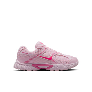 Youth running shoes in light pink with bright pink swoosh accents and lace-up design