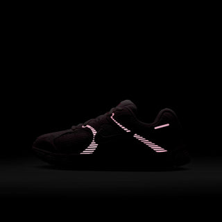 Youth running shoes in black with pink accents and swoosh on the side