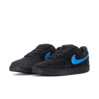 Black low-top sneaker pair with blue Swoosh accents on the sides