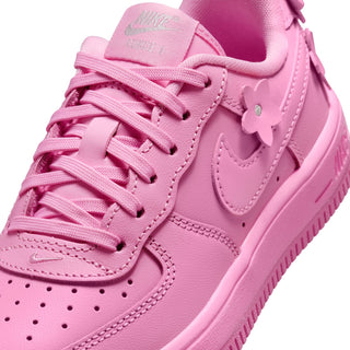 Kids' pink lace sneakers, close-up of laces, stitching, and flower heel tabs