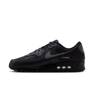 Men's Nike Air Max 90 PRM sneaker in dark grey/black, front-side view with Air Max badge