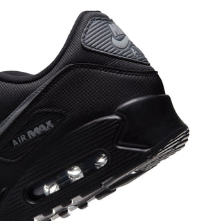 Close-up of Air Max 90 PRM heel, black upper with Air window and rubber outsole tread