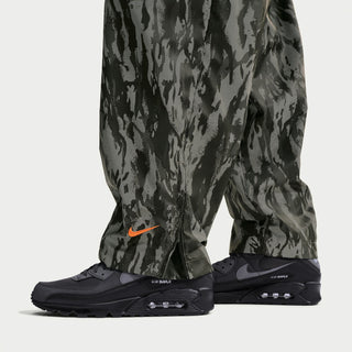 Men's Nike Air Max 90 PRM sneakers with camouflage pants, dark side view with Air unit