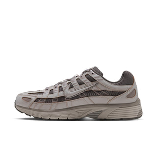 Men's lace-up running shoes side view in light bone and gray with swoosh accents