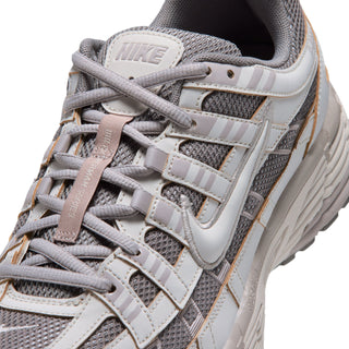 Men's sneaker upper close-up with lace rows, mesh panels, and Nike logo