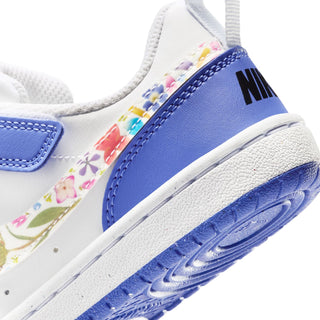 Kids sneaker close-up of midsole and heel, blue collar with Nike logo and blue sole