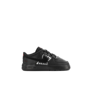 Kids' black low-top sneakers with lace-up closure, white panels, and red accents