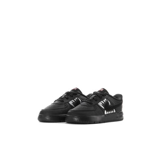 Kids' black low-top sneakers, pair view with lace-up closure and red accent details