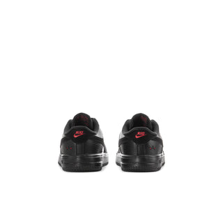 Kids' black low-top sneakers, back view with red heel details and Nike logo