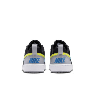 Youth low-top sneakers heel view: black back with yellow stripe and white outsole