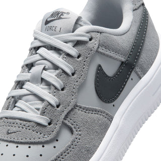 Kids Air Force 1 close-up: gray suede upper, white laces, swoosh, cushioned tongue.