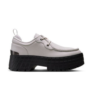 Light gray low-top sneakers with lace-up front and black chunky platform sole
