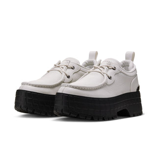 Pair of light gray lace-up sneakers with black treaded platform soles