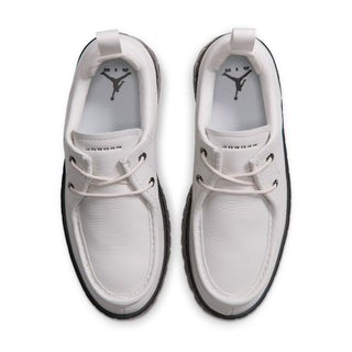 Front view of light gray low-top sneakers with laces and black rubber outsole trim