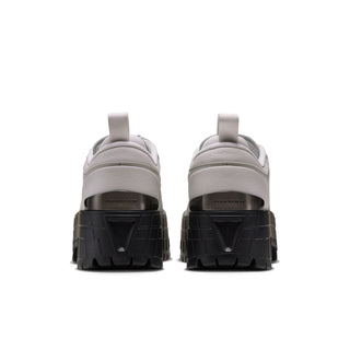 Back view of light gray sneakers with black heel panel and molded tread