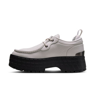 Side view of light gray lace-up sneakers with black platform sole