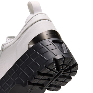 Close-up of light gray sneaker toe with black treaded rubber outsole