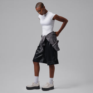 Womens light gray lace-up sneakers with black platform soles on a standing model