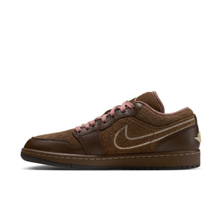 Womens low-top sneakers in brown with pink laces, white swoosh, and ridged sole