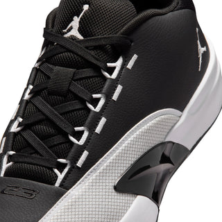 Men's black and white lace-up sneaker with textured side panel and small logo