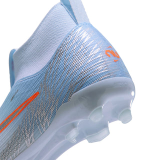 Youth light blue football boot with orange detailing and transparent FG/MG studs