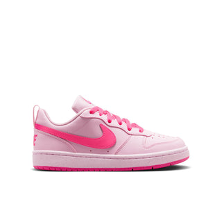 Youth pink low-top sneakers with pink swoosh, lace-up front, and white sole