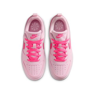 Youth pink low-top sneakers with lace-up front, patterned lining, and swoosh details