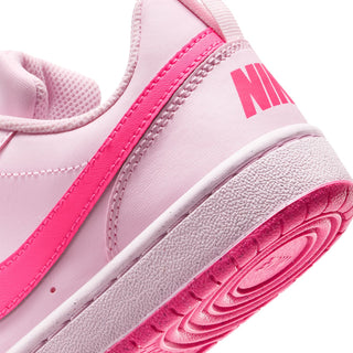 Youth pink sneaker side and outsole close-up with NIKE branding and textured tread