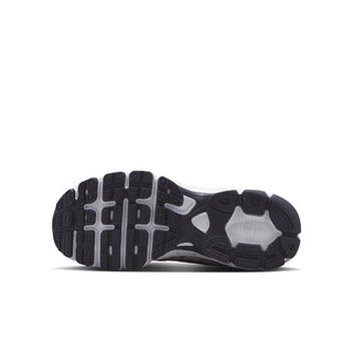 Youth sneakers outsole view with dark tread and visible cushioning pods