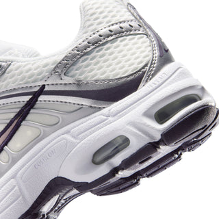 Close-up of youth white sneaker midsole with air cushioning pods and purple outsole edge