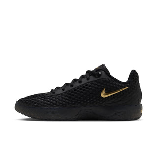 Men's black low-top sneakers with gold swoosh-style logo and lace-up