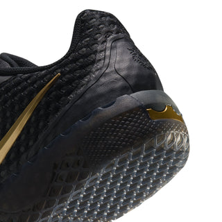 Men's black sneaker side view with metallic gold trim and grippy sole