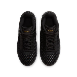Pair of youth black sneakers with black laces and small metallic gold accents