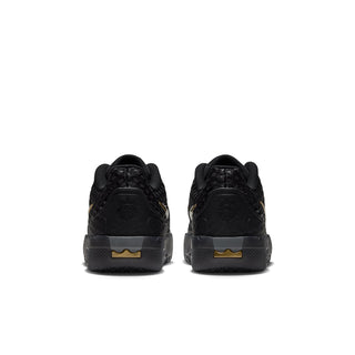 Youth black sneakers rear view with lace-up closure and metallic gold heel details