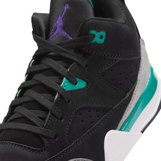 Kids black sneakers close-up with teal laces, teal tongue tag, and purple logo