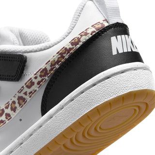 Kids sneaker close-up of black heel with NIKE logo and tan gum outsole tread