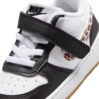 Toddler sneaker close-up: white laces, black strap, NIKE tongue, leopard side detail
