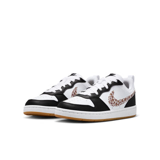 Youth low-top sneakers, pair view with white uppers, black sides, leopard Swoosh
