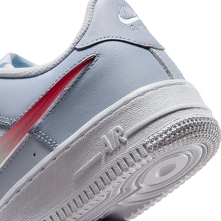 Close-up of youth sneaker side and midsole, showing red accent and 'AIR' detail