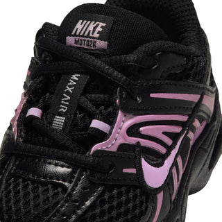 Black toddler sneaker close-up with pink Swoosh, Nike tag, and stitched laces