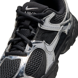 Youth black and metallic silver shoe, close-up of laces, mesh panels, and Nike logo