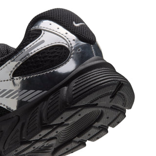 Youth black and metallic silver sneaker, close-up of side and outsole tread details