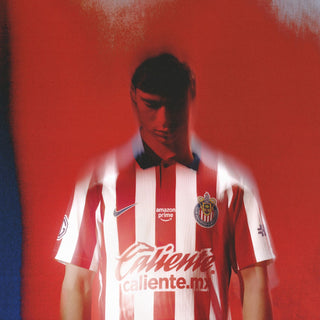 Men’s home soccer jersey in red and white stripes with blue collar and crest