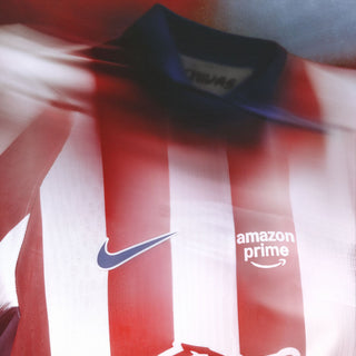 Front close-up of red and white striped soccer jersey with Nike swoosh