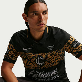 Mens black soccer jersey with gold patterned shoulders, Nike swoosh, Caliente.mx chest