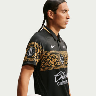 Mens black soccer jersey with gold ornate sleeve panels and Caliente.mx side print