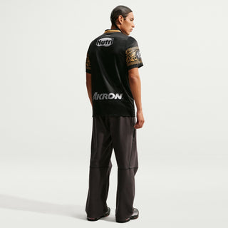 Mens black soccer jersey back view with gold trim and AKRON sponsor mark
